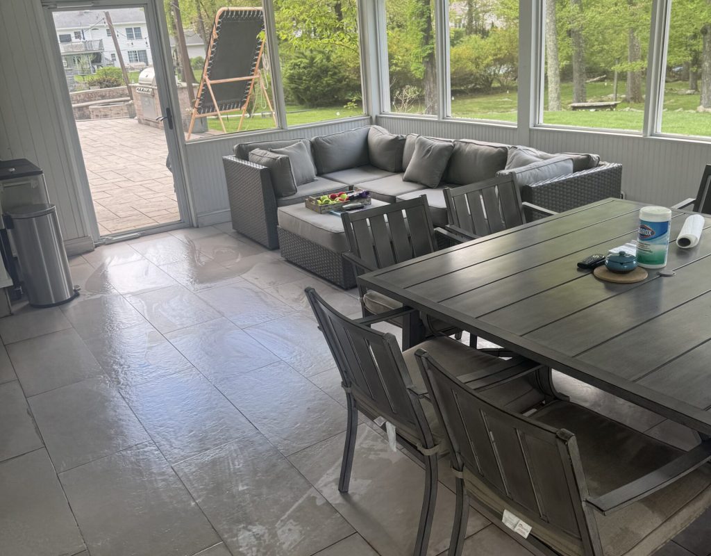 House cleaning staff vacuuming carpet and dusting decorative home surfaces