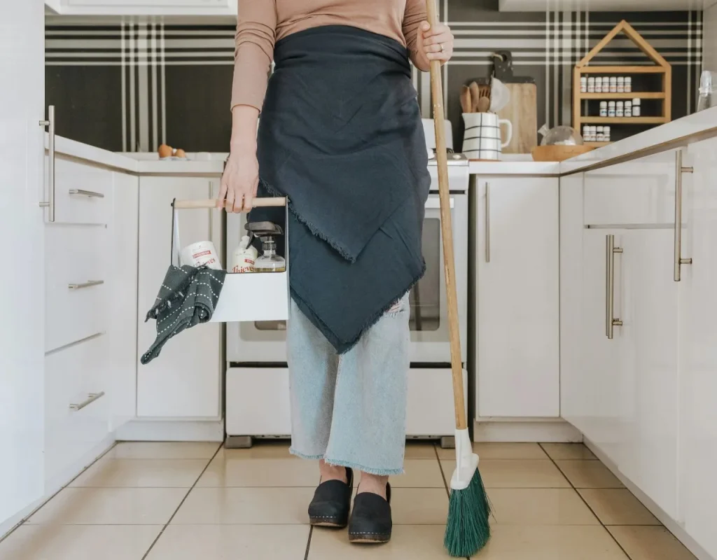 Person wiping a bathroom vanity and fixtures in a Chandler, AZ home.