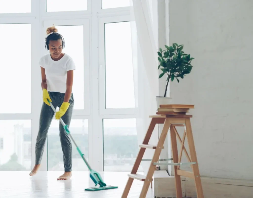 Person wiping entryway surfaces and high contact areas in a Mesa, AZ home.