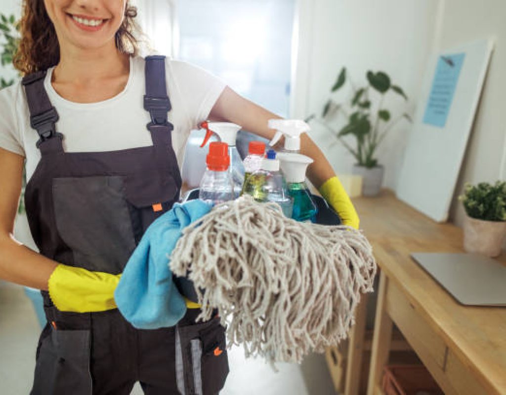 Professional cleaners wiping countertops and sanitizing a modern residential kitchen