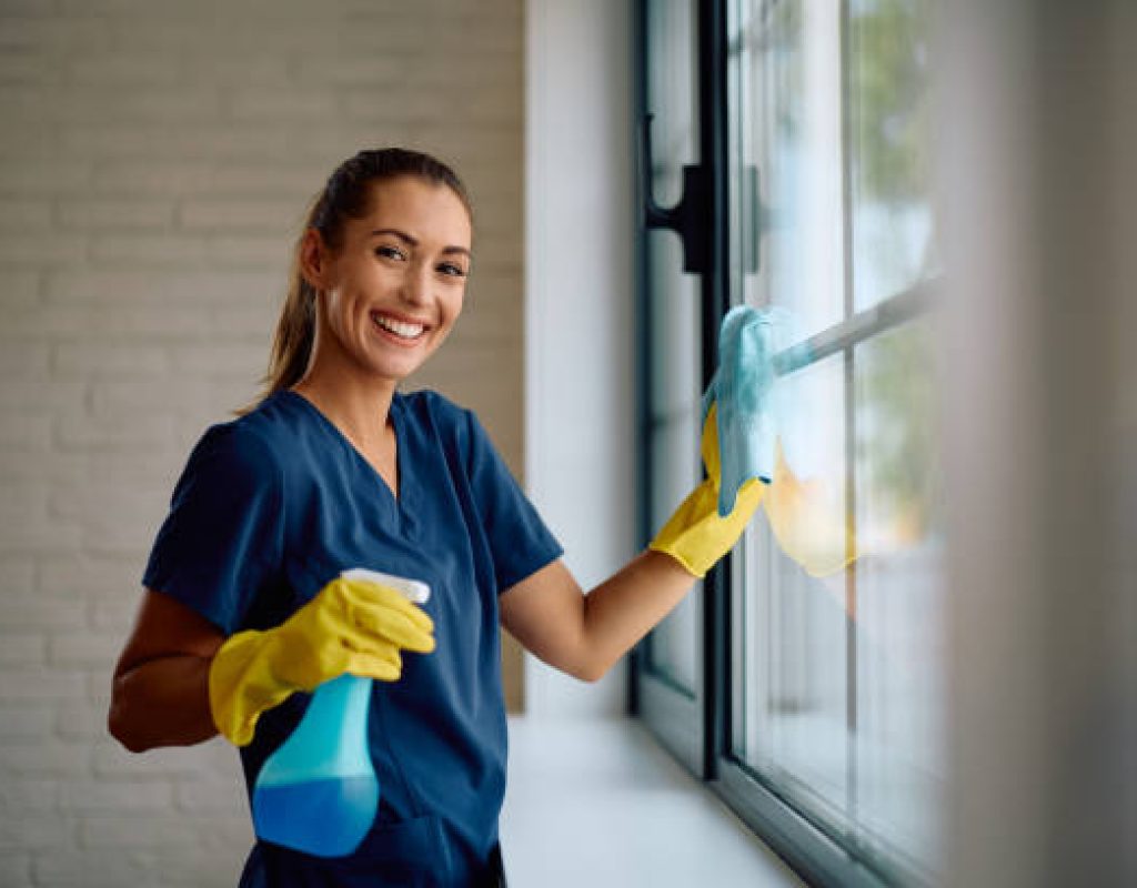 Cleaner preparing dusty Apache Junction kitchen counters before weekend family guests arrive