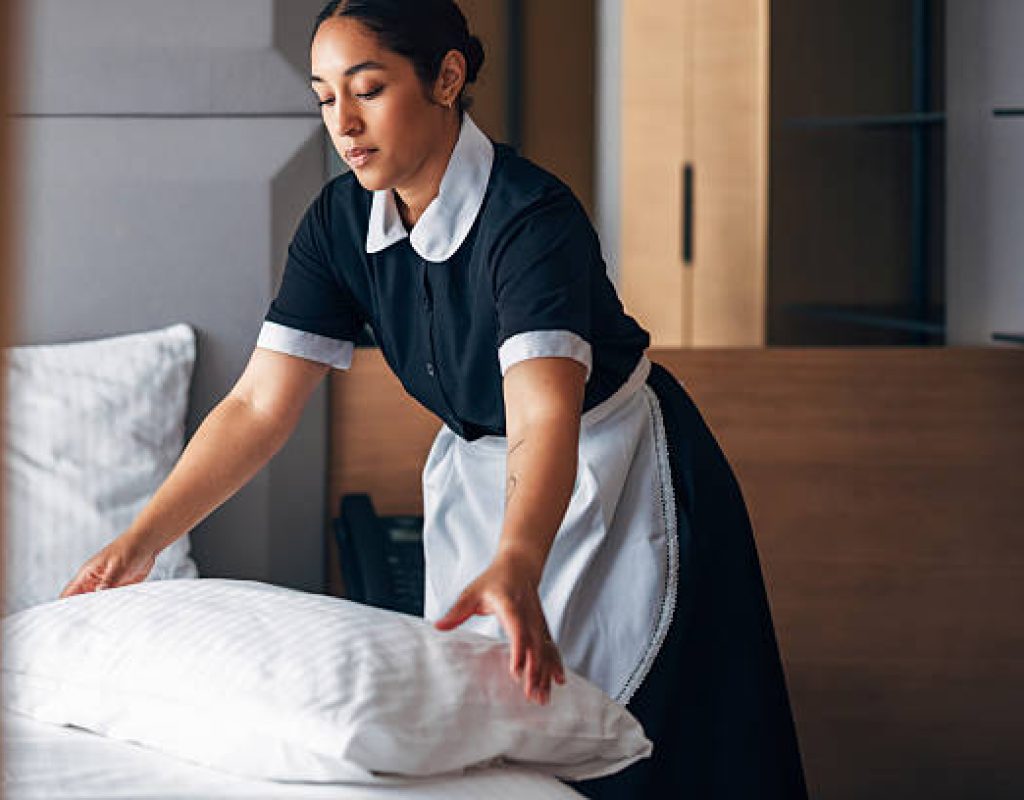 Expert maid using microfiber cloth to polish fixtures in upscale Gilbert, AZ kitchen